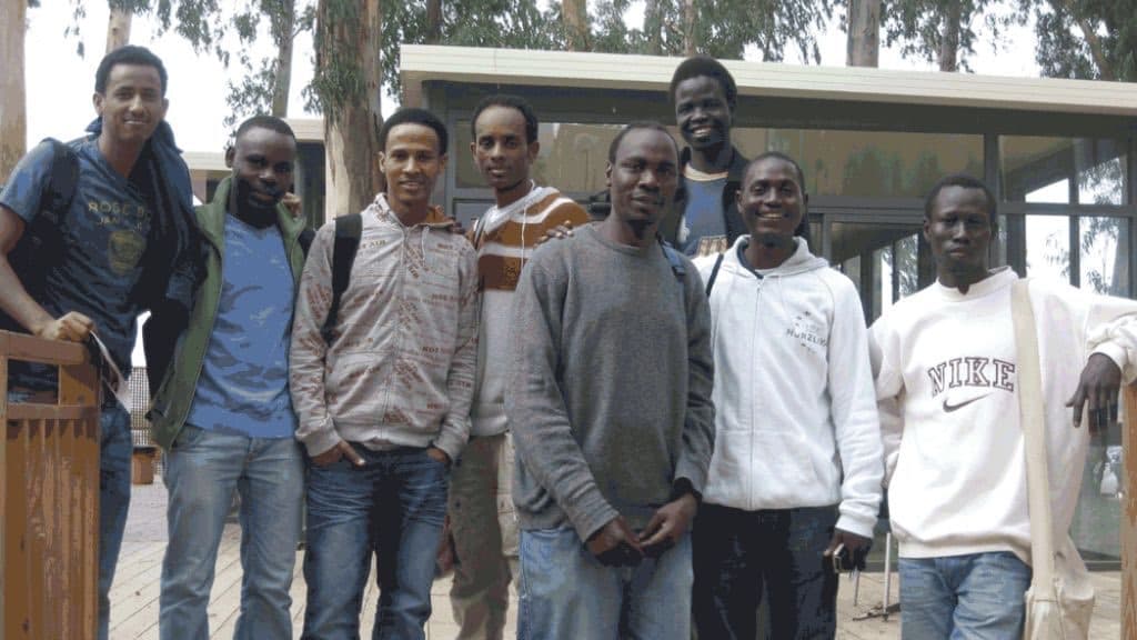 A group of young African students standing together on an Israeli university campus.