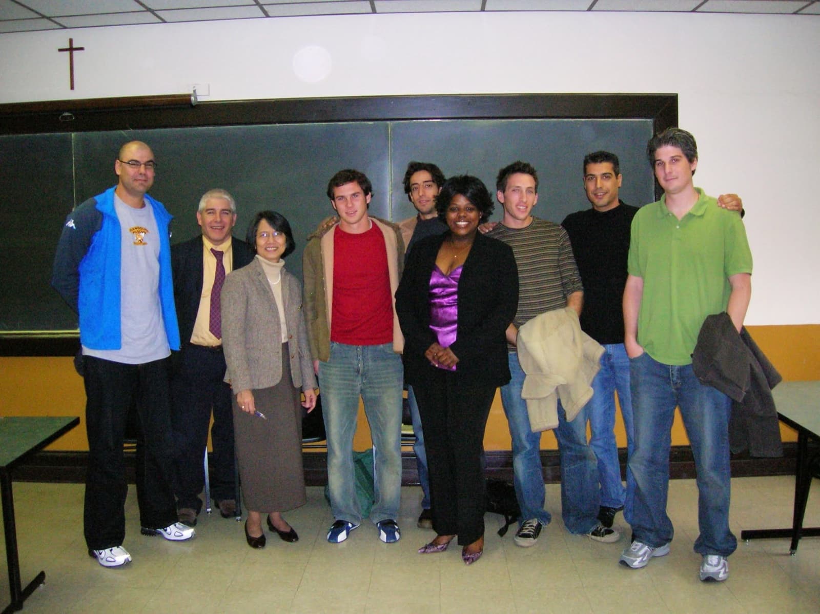 Israeli players posing with faculty and hosts in a college classroom after a game.