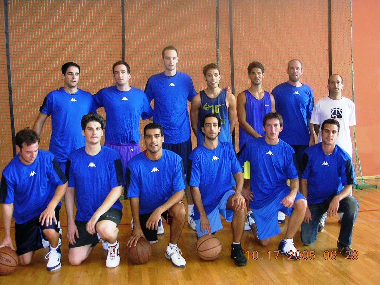 The Israel at Heart basketball squad in matching blue shirts, posed together in a gym.