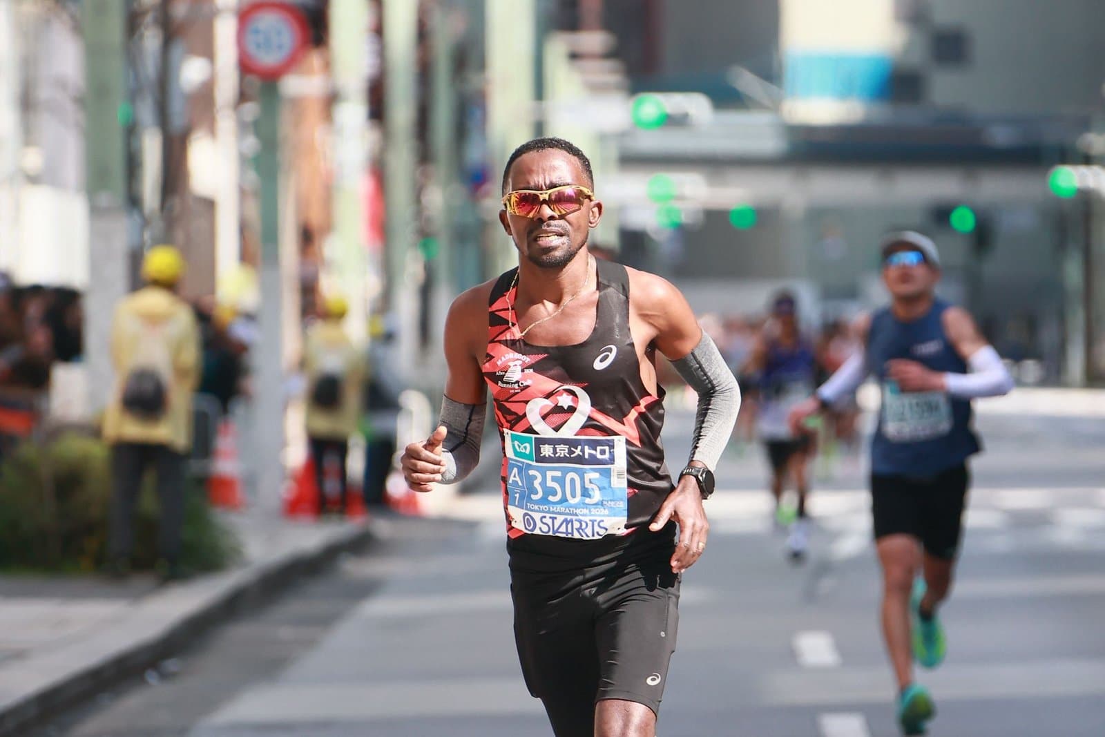 An Israeli runner mid-race on a city marathon course.