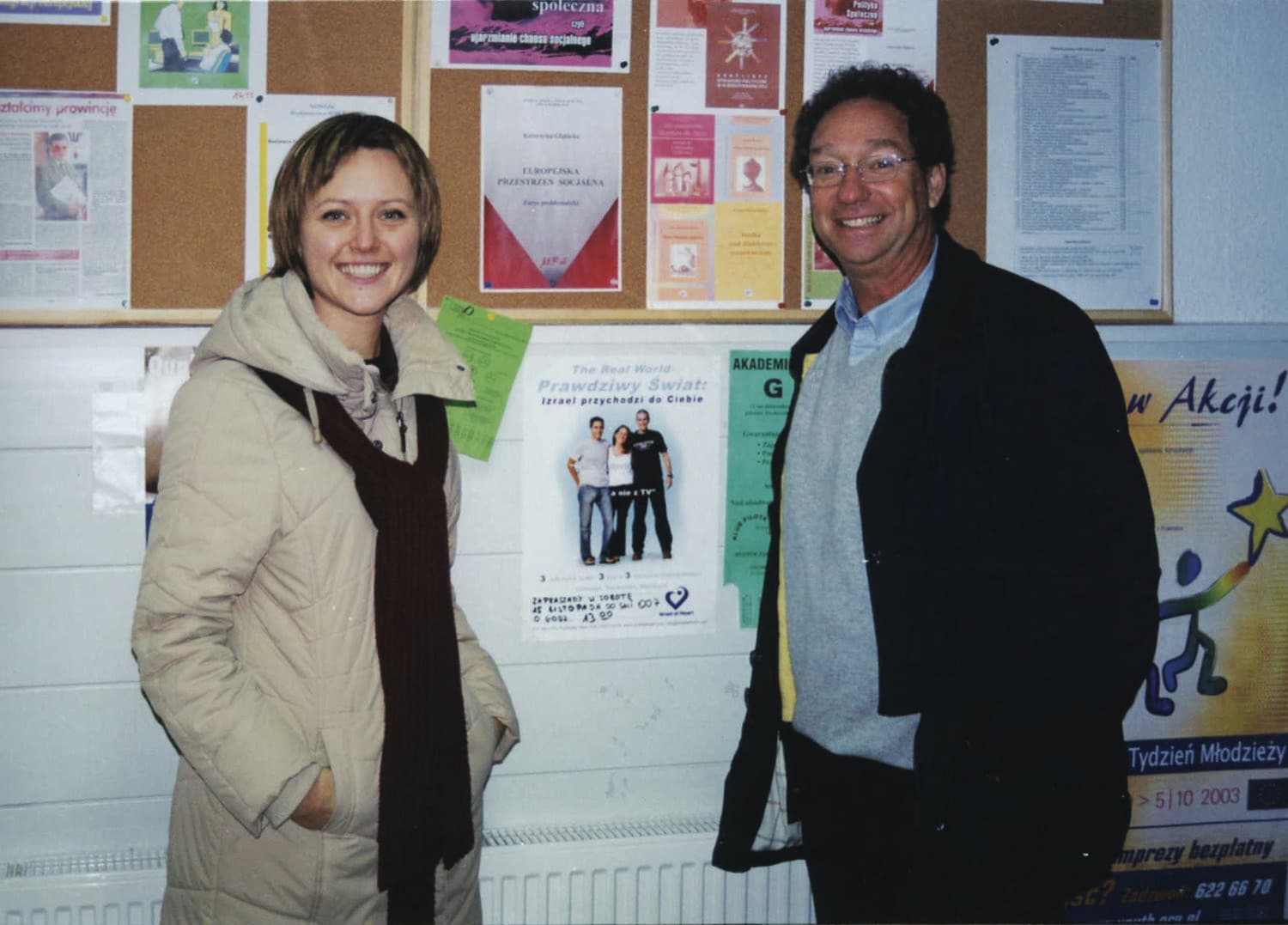 A delegate beside an Israel at Heart poster on a European campus.