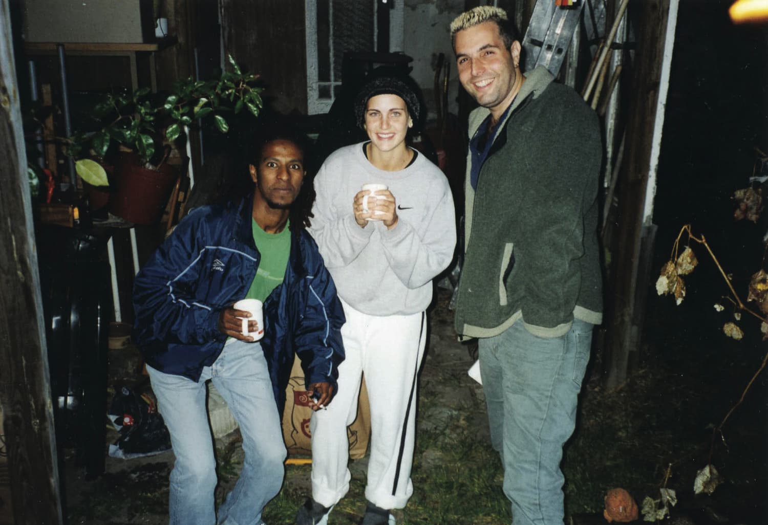 Three delegates with mugs of coffee on a delegation stop in Sweden.