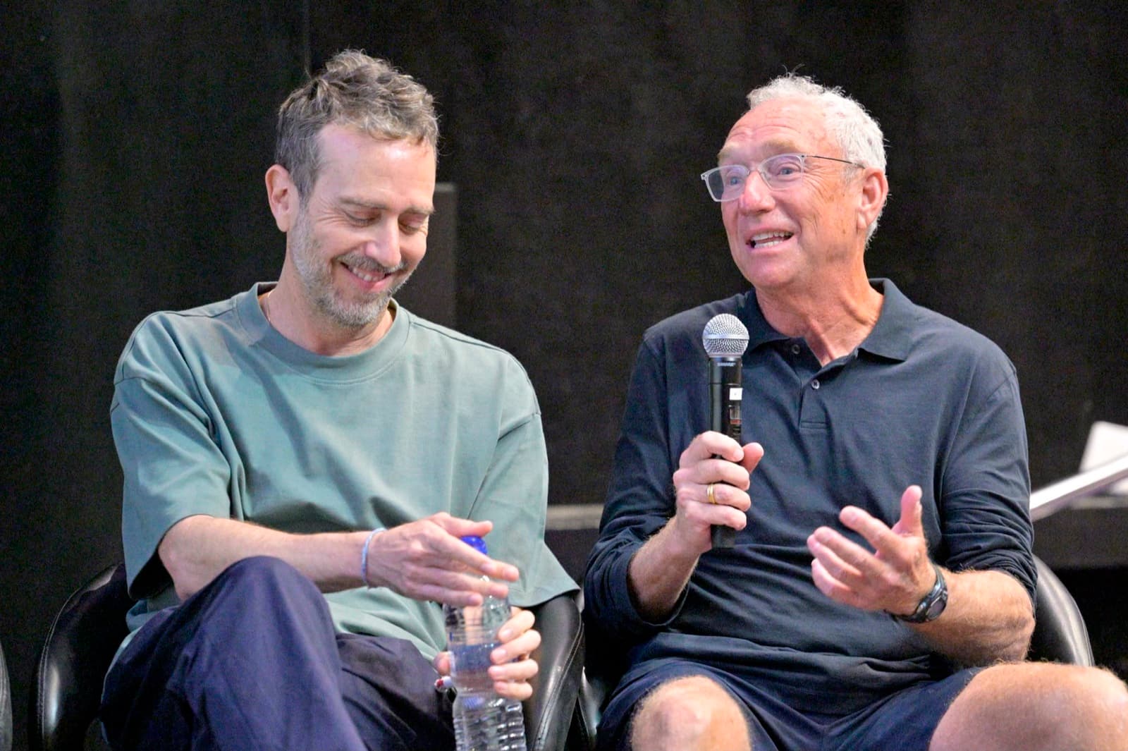Two panelists in animated conversation during a discussion at the festival.