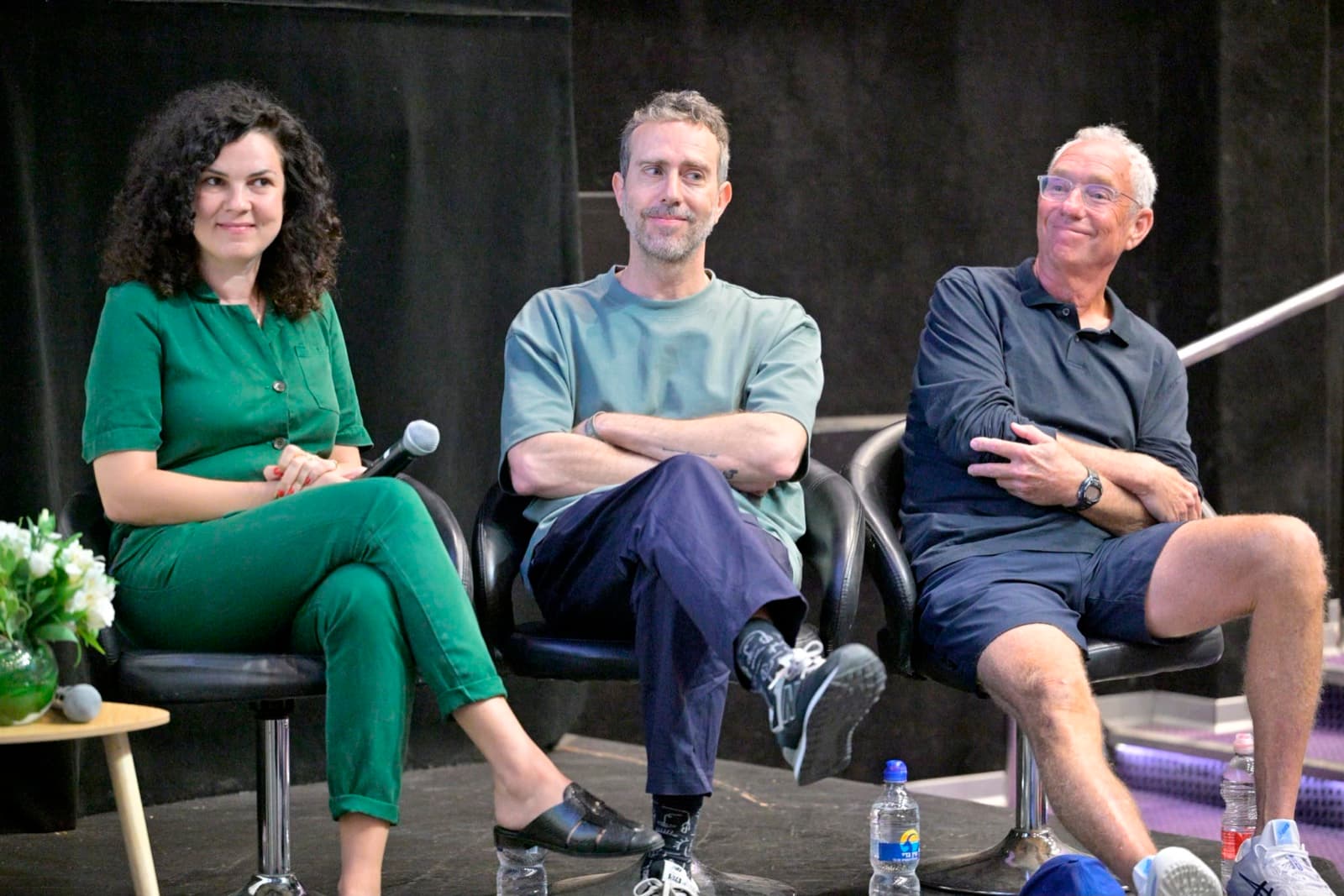 Anat Stalinsky, Meny Aviram, and Joey Low seated on stage in conversation at OctoberDoc.