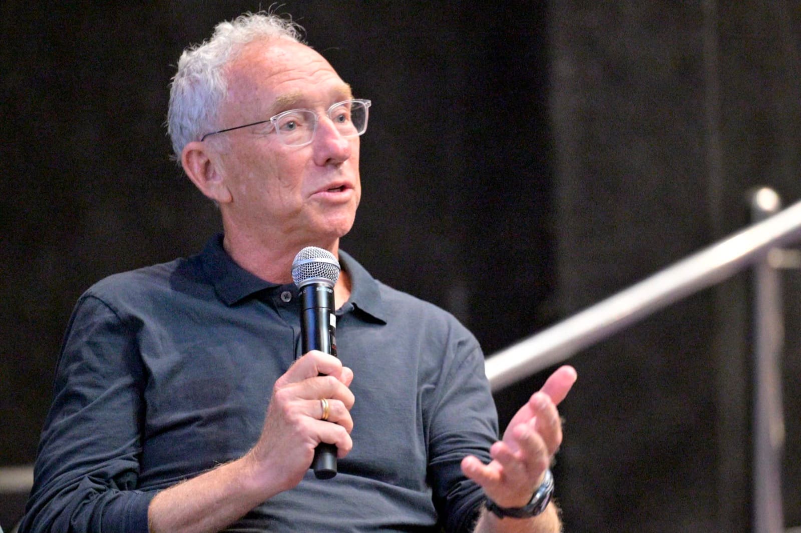 A participant speaking into a microphone during a panel.