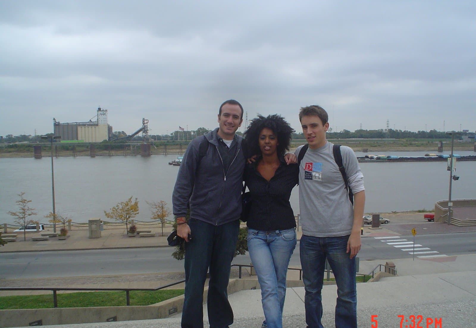 Three delegates posed together at a riverfront during the United States tour.