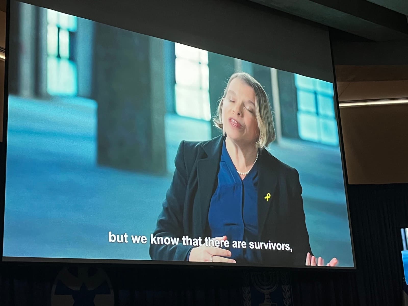 The film on a large screen at a Foreign Ministry screening, a survivor's testimony subtitled.